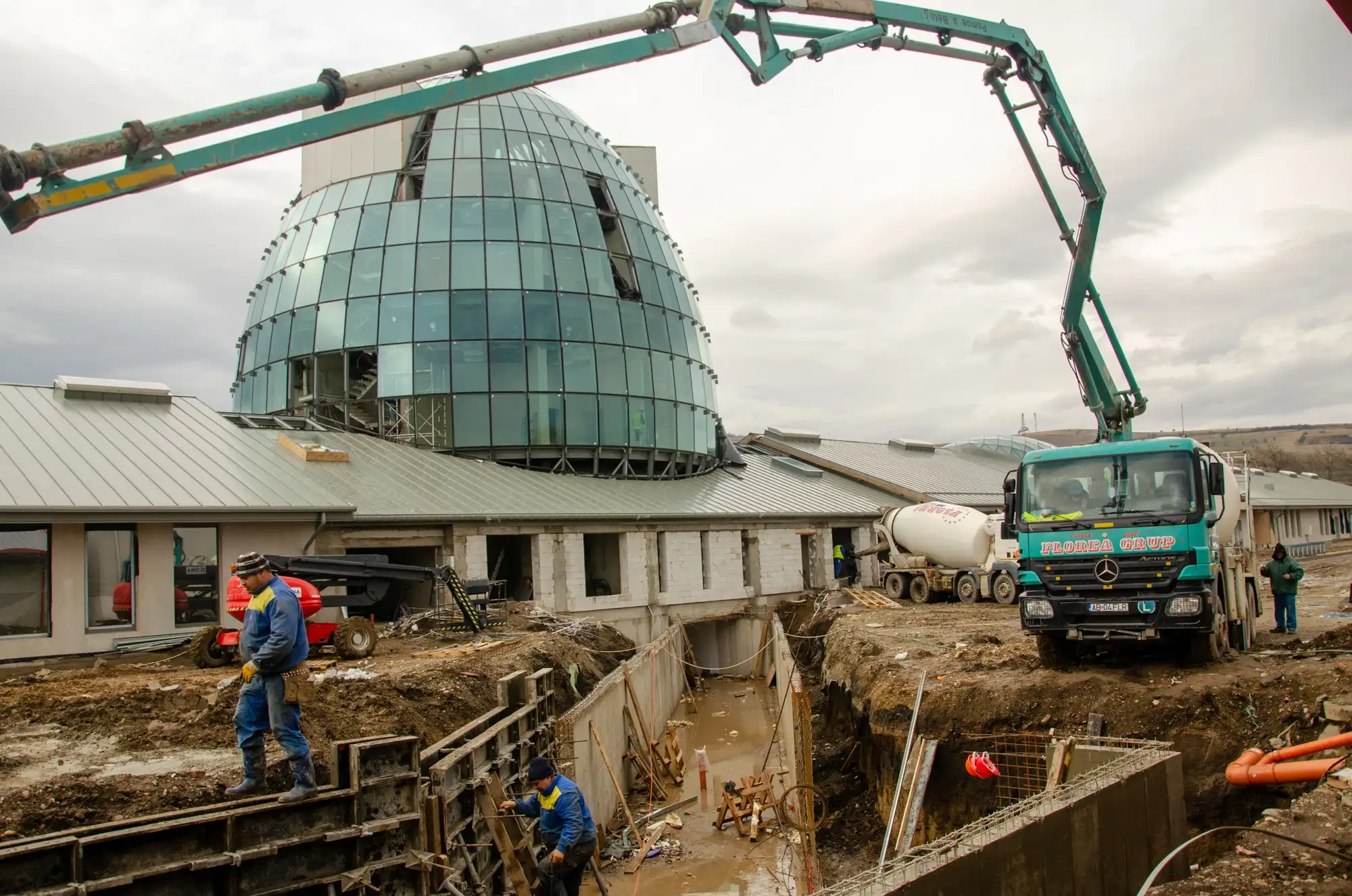 Pompă de beton lângă o clădire cu cupolă de sticlă