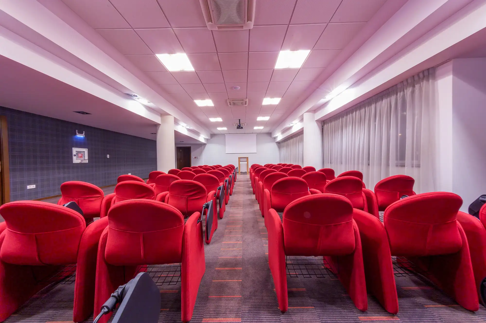Sală de conferințe cu scaune roșii la Hotel Transilvania
