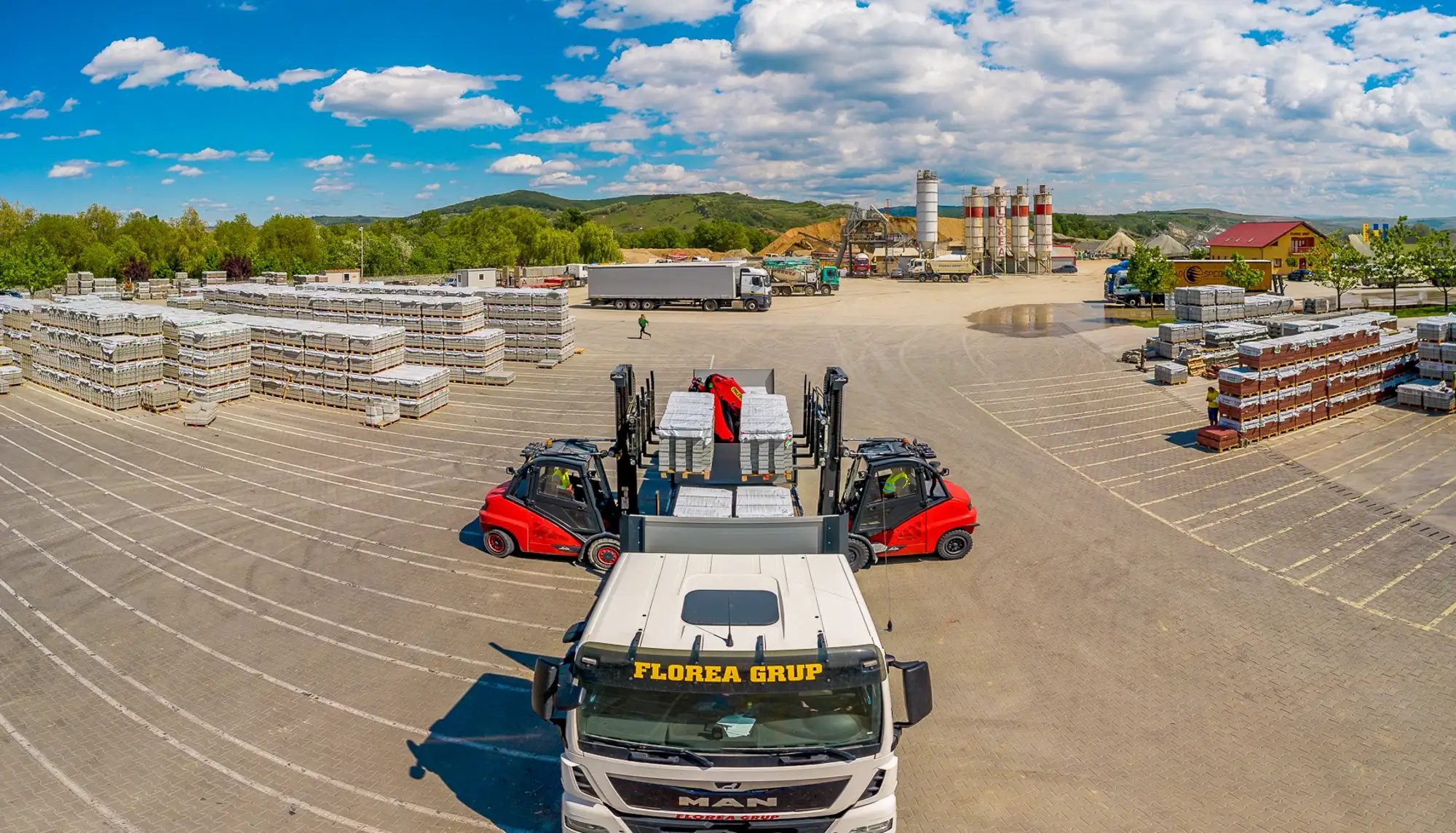 Stivuitoare și camion Florea Grup în curtea de depozitare a fabricii